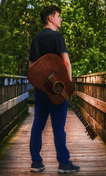 Christopher with guitar on the bridge